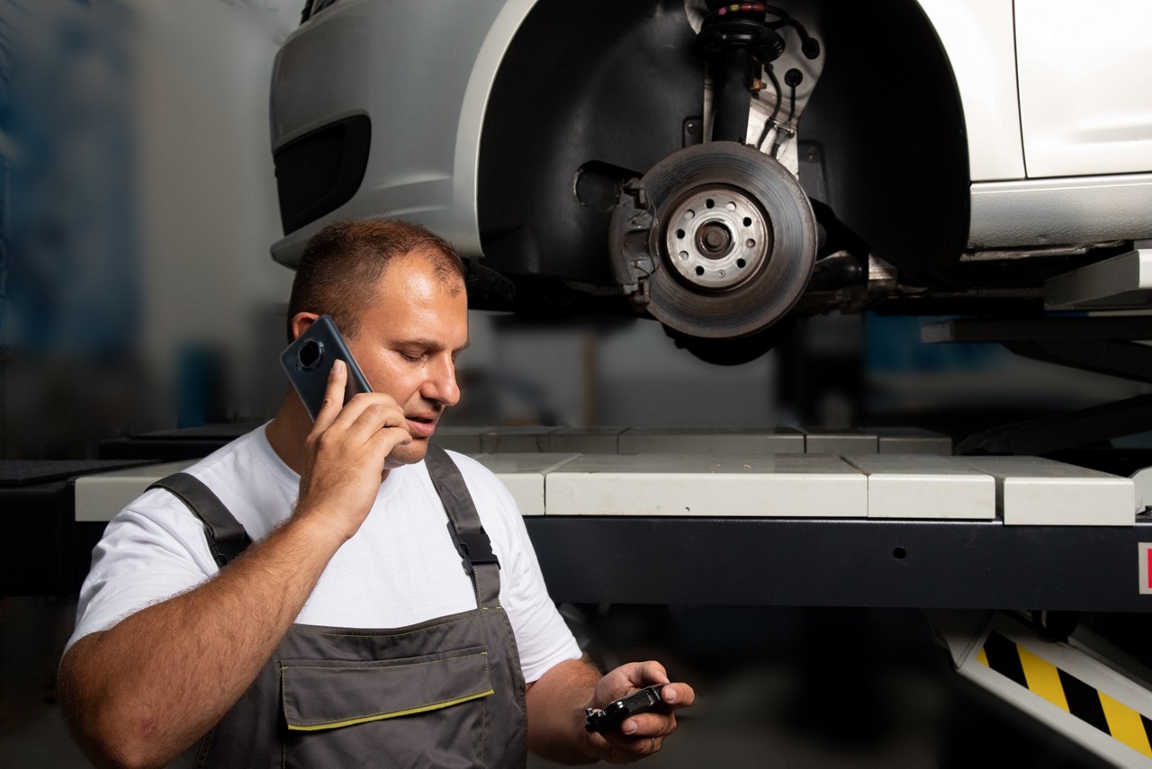 Garage Gurus mechanic attending a technical call at a garage