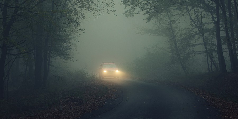 Car-On-Dark-Road-with-Lights-On