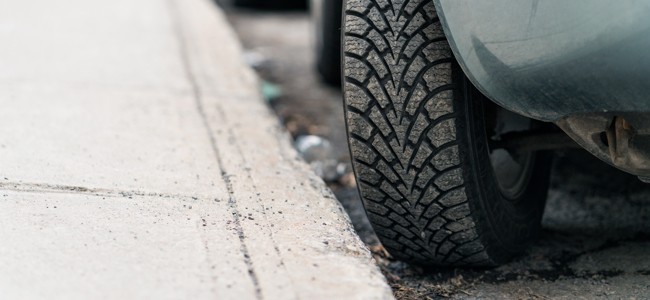 Car-Tire-Close-Up-Near-Curb