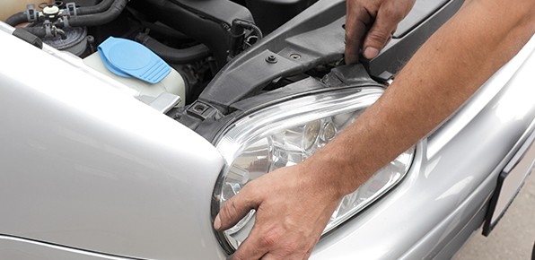 Mechanic-Examining-Headlight-Housing