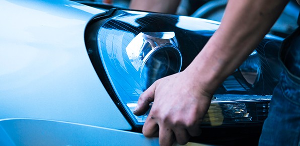 Man-Removing-Headlight-Housing