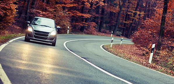 Vehicle-on-Curvy-Road-with-Headlights-On