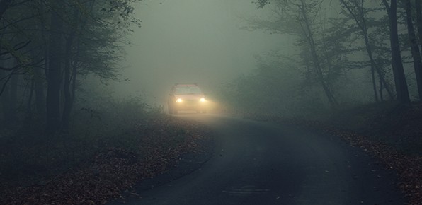 Car-On-Dark-Road-with-Lights-On